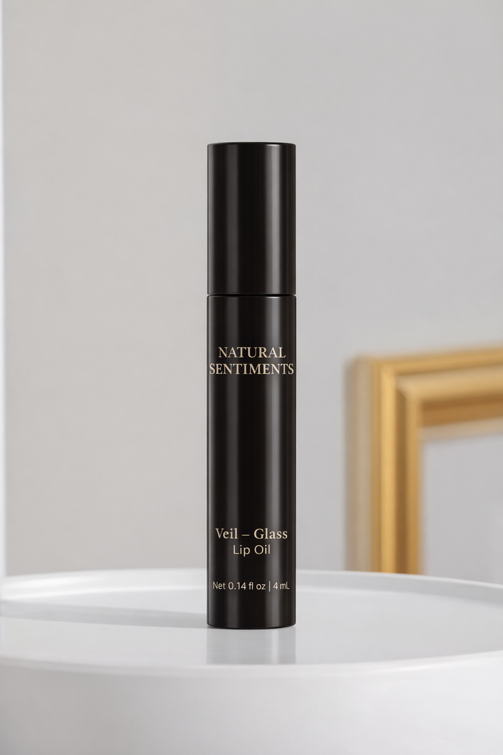 Black biodegradable cylindrical tube with brand name, "Natural Sentiments," name of lip oil "Veil" and color of lip oil, "Glass" Net weight 0.14 fl oz. approximately 4ml